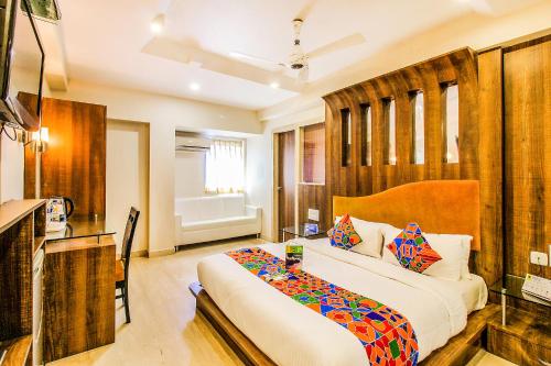 a bedroom with a large bed in a room at FabHotel Sahar Garden Marol in Mumbai