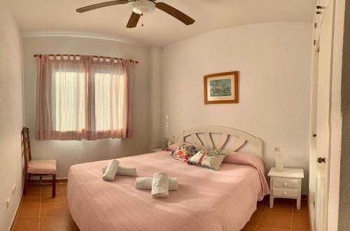 a bedroom with a bed with two towels on it at Zahara almadraba playa Atlanterra in Zahara de los Atunes