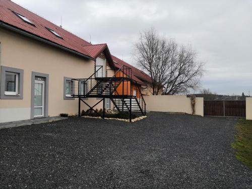 a house with a spiral staircase on the side of it at Vehlovice Apartments in Mělník