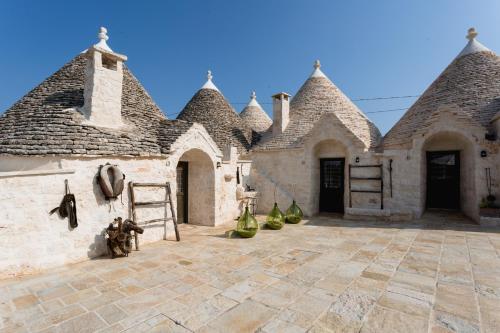 a stone building with turrets and a courtyard at Borgo D'Itria in Monopoli