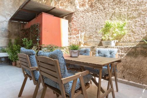 a wooden table and chairs on a patio at Cozy Flat with Terrace & Patio, next to Lycabettus in Athens