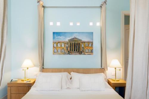 Ένα ή περισσότερα κρεβάτια σε δωμάτιο στο Palazzo Brunaccini Boutique Hotel