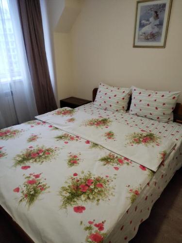 a bedroom with a bed with flowers on it at Kiev City Hotel in Kyiv
