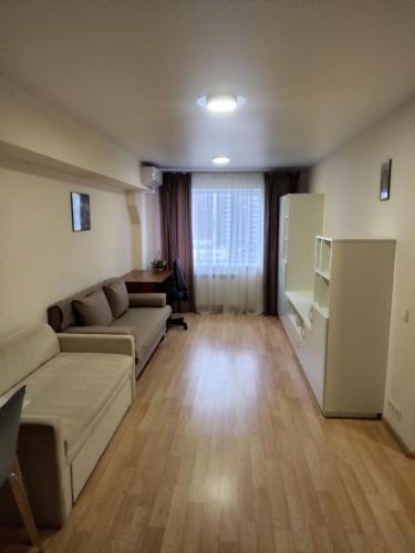a living room with a couch and a refrigerator at Kiev City Hotel in Kyiv