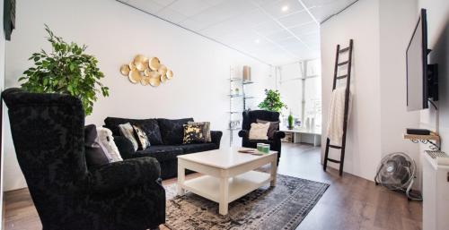 a living room with a couch and a table at Luxurious two bedroom apartment A kwartier Center in Groningen