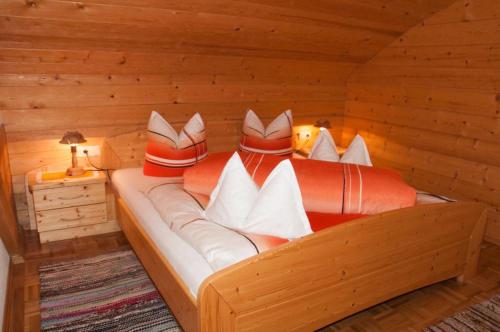 a bedroom with a bed in a log cabin at Mooserhof in Maria Luggau