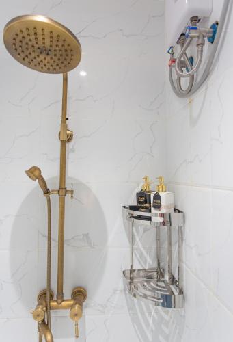 a bathroom with a shower head and a sink at Bohol Sojourn Villa Alona in Panglao