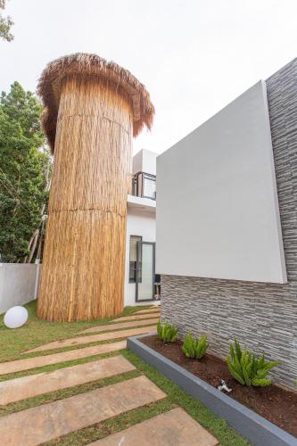 a tree in front of a building with a billboard at Bohol Sojourn Villa Alona in Panglao