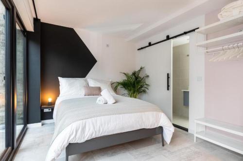 a bedroom with a large bed with white sheets at 2 rooms Sea Breeze loft apartment II terrace family Scheveningen The Hague in Scheveningen