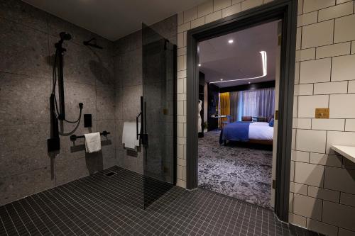 a bathroom with a toilet, sink, and shower stall at Hotel Brooklyn Manchester in Manchester