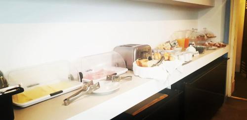 a kitchen counter with a bunch of food on it at Hotel Intorno Al Fico in Fiumicino