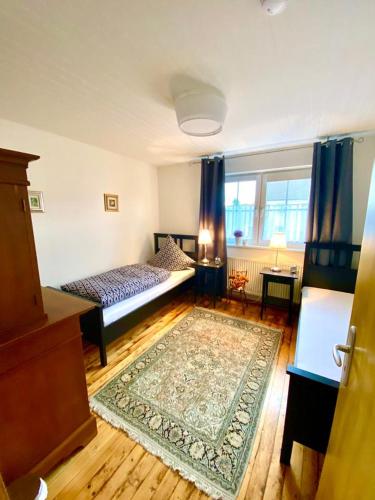 a bedroom with two beds and a rug on the floor at Ferienwohnung in Münchsmünster