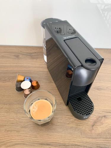 a coffee maker sitting on top of a wooden table at Escamp Apartments in The Hague