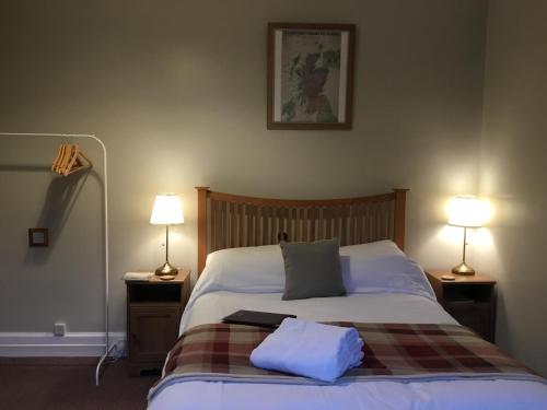 a bedroom with a bed with two pillows on it at DAVAAR B&B in Dufftown