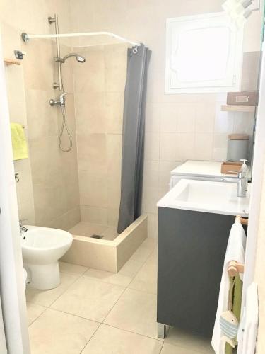 a bathroom with a shower and a toilet and a sink at CALA BLANCA-TORRE BELLVER in Cala Blanca