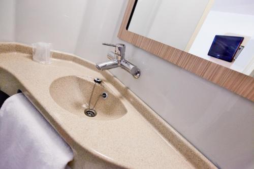 a bathroom with a sink and a mirror at Premiere Classe Blois Nord in Blois