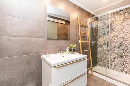 a bathroom with a sink and a shower at Belem Skinny House in Lisbon