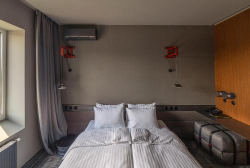 a bedroom with a bed with two white pillows at Дизайн-готель ROAD in Kyiv