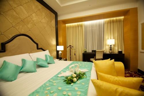 Un pat sau paturi într-o cameră la Perdana Kota Bharu