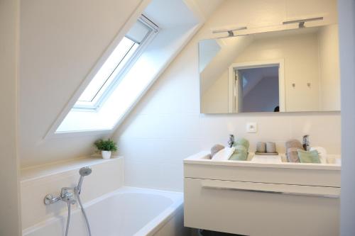 a bathroom with a sink and a mirror at Maison Marie in Middelkerke