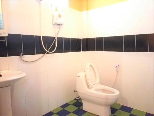 a bathroom with a toilet and a sink at Phurafa Resort in Phang-nga