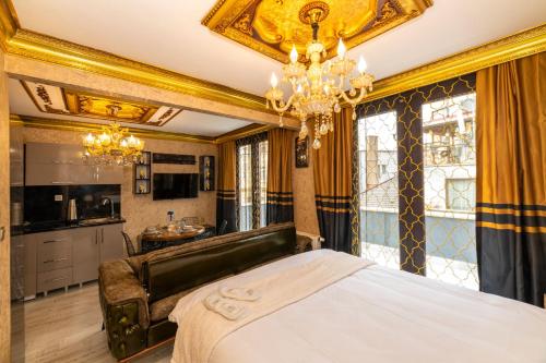 a bedroom with a bed and a chandelier at By Mesut Residence - Taksim Cihangir in Istanbul