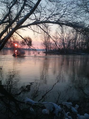 a view of a river with snow on the water at Maison bois in Germigny-des-Prés