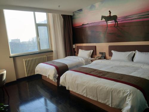 a hotel room with two beds and a horse painting on the wall at Thank Inn Chain Hotel shanxi jinzhong yuci ditrict no.2 middle school in Jinzhong