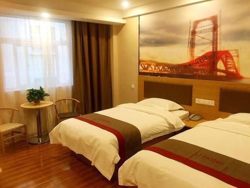 a hotel room with two beds and a window at Thank Inn Chain Hotel shandong zaozhuang central district long-distance bus station in Zaozhuang
