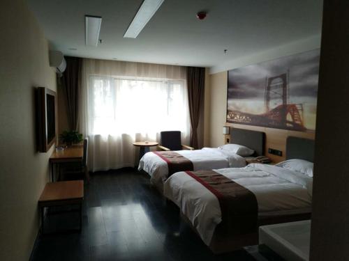 a hotel room with two beds and a window at Thank Inn Chain Hotel Shanxi jinzhong Taigu County xingangwan shopping plaza in Jinzhong