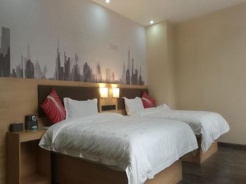 two beds in a bedroom with a city mural on the wall at Thank Inn Chain Hotel guangxi liuzhou wal-mart jinfudi in Liuzhou