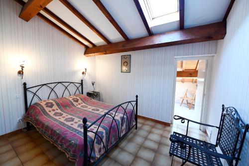 a bedroom with a bed in a room with a window at superbe duplex bord de mer in Port-Vendres