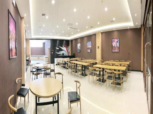 une salle à manger avec des tables et des chaises dans un bâtiment dans l'établissement Thank Inn Chain Hotel hebei handan yongnian district development road, à Handan