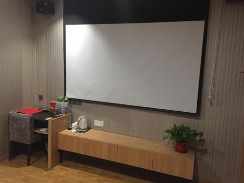 a large projection screen on the wall of a room at Thank Inn Chain Hotel henan kaifeng lankao county chengguan town government in Kaifeng