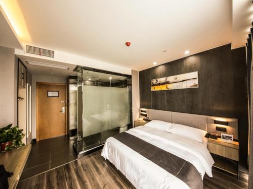 a bedroom with a large bed and a shower at Thank Inn Plus Hotel Jiangsu huaian huaiyin area of the Yangtze river east road in Huai'an