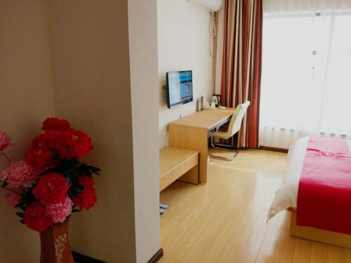 Habitación con escritorio, cama y ordenador. en Thank Inn Chain Hotel hubei wuhan caidian district lianhua lake avenue, en Wuhan