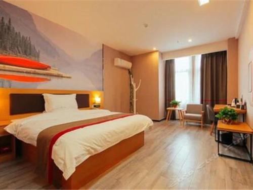 a hotel room with a bed and a large window at Thank Inn Chain Hotel henan zhengzhou future road convention and exhibition center in Zhengzhou