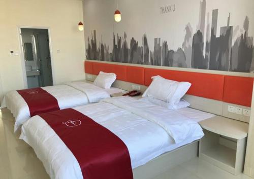 Krevet ili kreveti u jedinici u okviru objekta Thank Inn Chain Hotel jiangxi fuzhou linchuan district new no.3 middle school