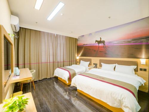 a hotel room with two beds and a painting on the wall at Thank Inn Chain Hotel shanxi jinzhong yuci ditrict no.2 middle school in Jinzhong