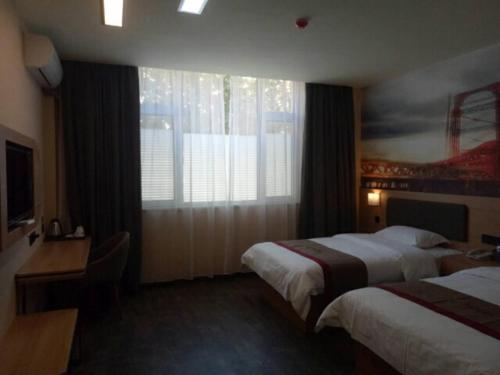 a hotel room with two beds and a window at Thank Inn Chain Hotel shandong binzhou bincheng district binbei in Binzhou