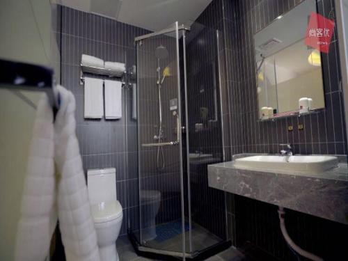 a bathroom with a shower and a toilet and a sink at Thank Inn Chain Hotel anhui bengbu huaishang district mohekou county in Bengbu