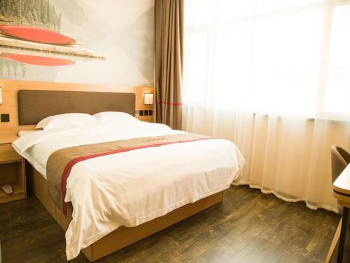 a bedroom with a large bed with a window at Thank Inn Chain Hotel shanxi jinzhong yuci ditrict shuncheng west street in Jinzhong