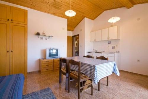 a kitchen and dining room with a table and chairs at Little Heaven on Earth - Apartmani Martina in Vlašići