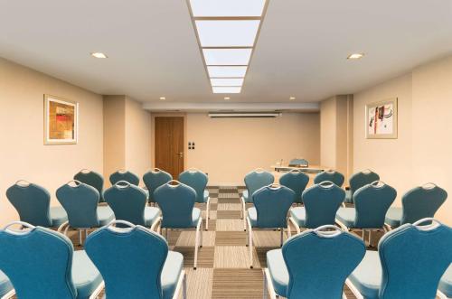 a conference room with blue chairs and a table at Radisson Blu Ankara in Ankara
