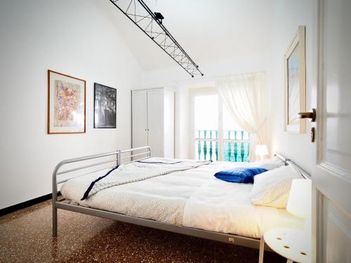 a white bedroom with a bed and a window at DIMORA LUCCOLI ACQUARIO - GENOVABNB it in Genova