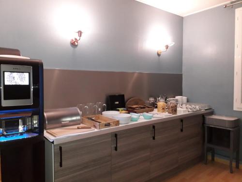 a kitchen with a counter with food on it at Hotel de Normandie in Gournay-en-Bray