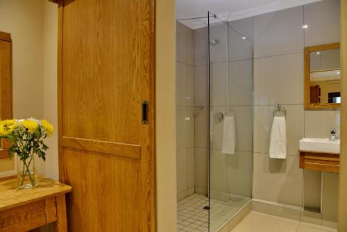 a bathroom with a shower with a glass door at La Perle in Ballito