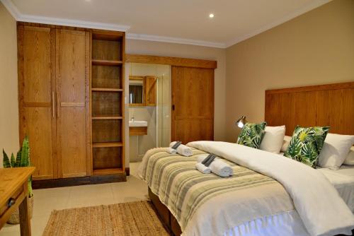 a bedroom with two beds and a bathroom at La Perle in Ballito