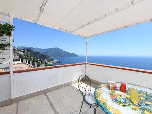a table on a balcony with a view of the ocean at Hotel Villa Felice Relais in Amalfi