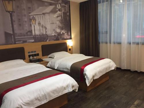 a hotel room with two beds and a window at Thank Inn Chain Hotel guizhou zunyi chishui city red army avenue jinshui bay in Chishui
